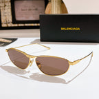 Oval brown tinted sunglasses with gold metal frame and thin temples