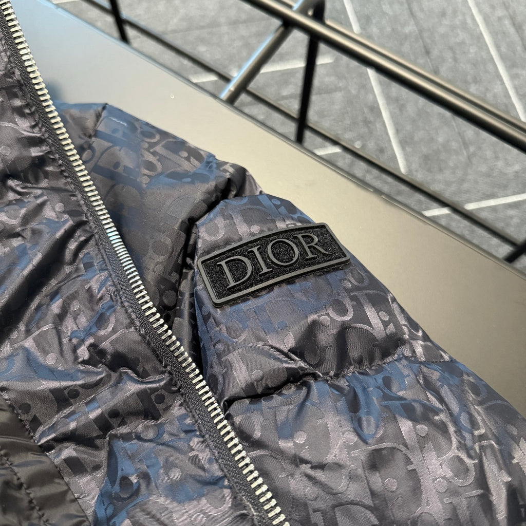 Dior logo patch on hood, zip-front long puffer jacket in gray-blue monogram pattern.