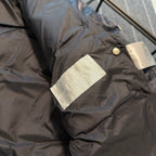 Dior logo fabric label on sleeve cuff of long puffer jacket, dark gray-blue.