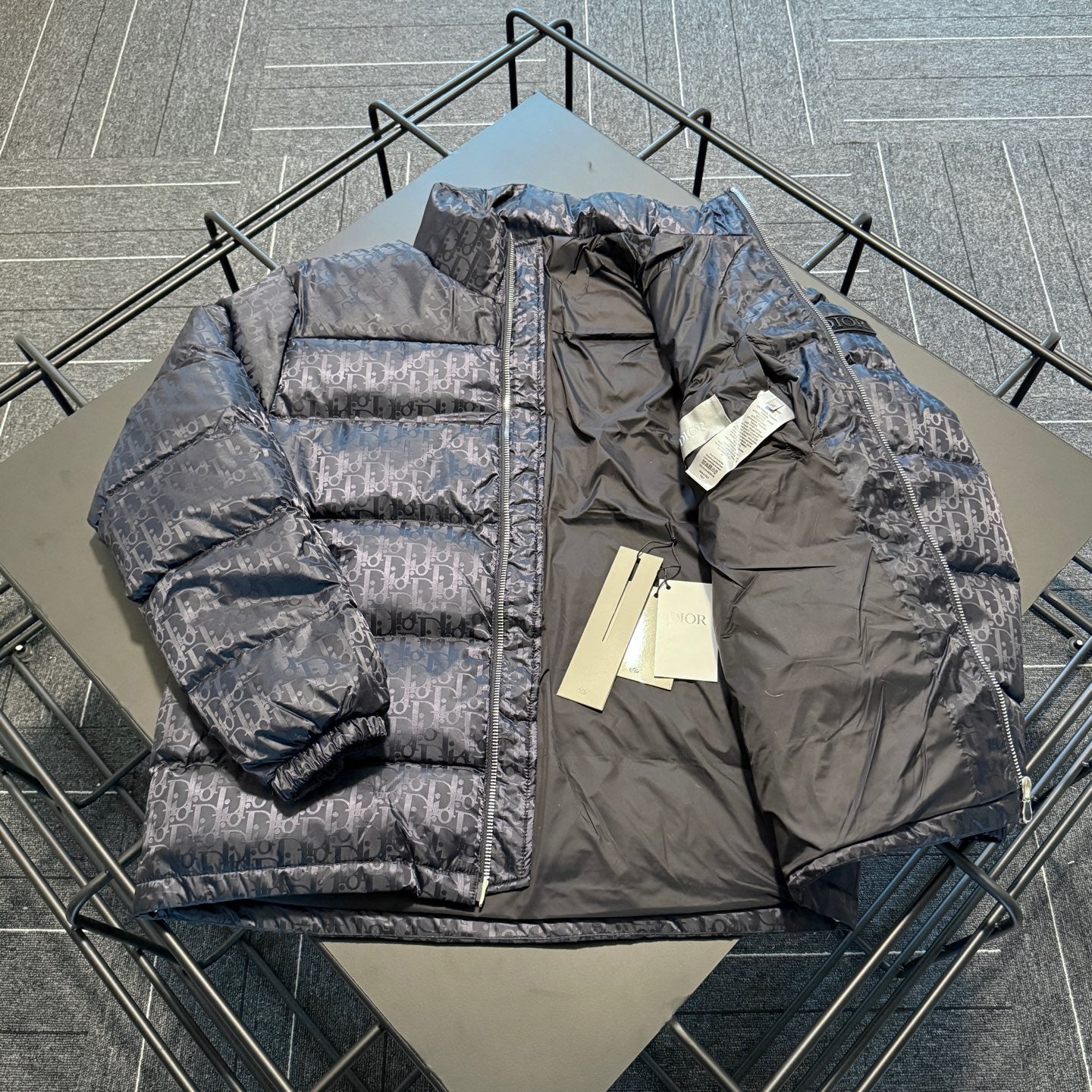 Dior long puffer jacket, quilted logo pattern, front zip and stand collar detail.