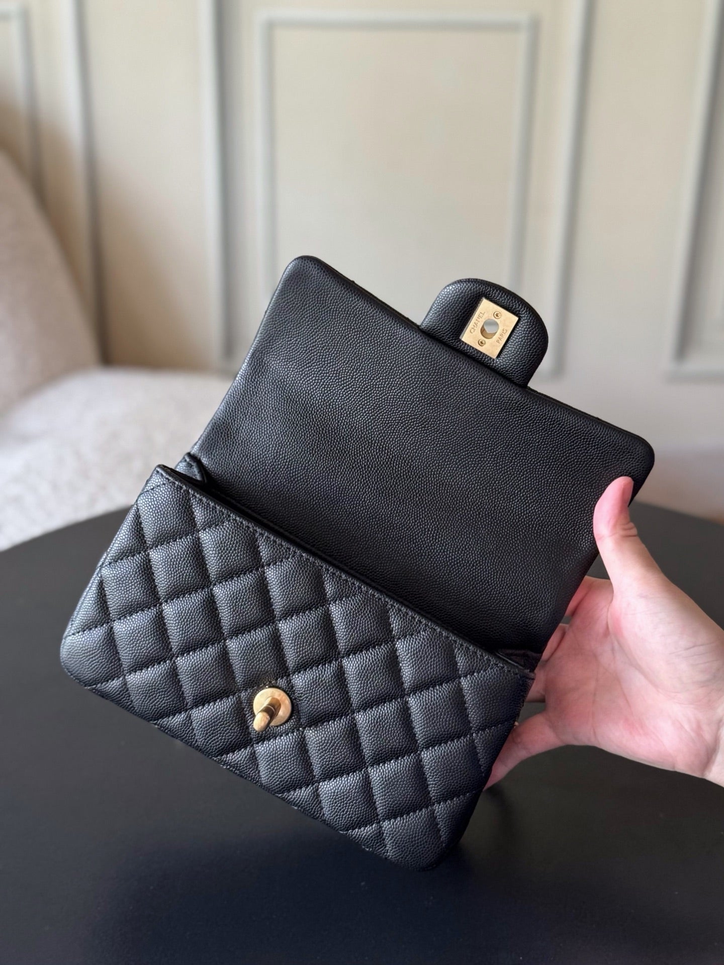 Chanel quilted mini handbag with front flap and wrist strap, black leather