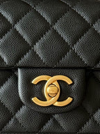 Chanel CC logo clasp on quilted black leather mini handbag