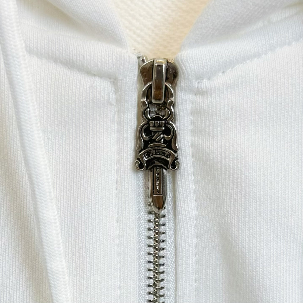 White hoodie front zipper with metallic pull and teeth detail