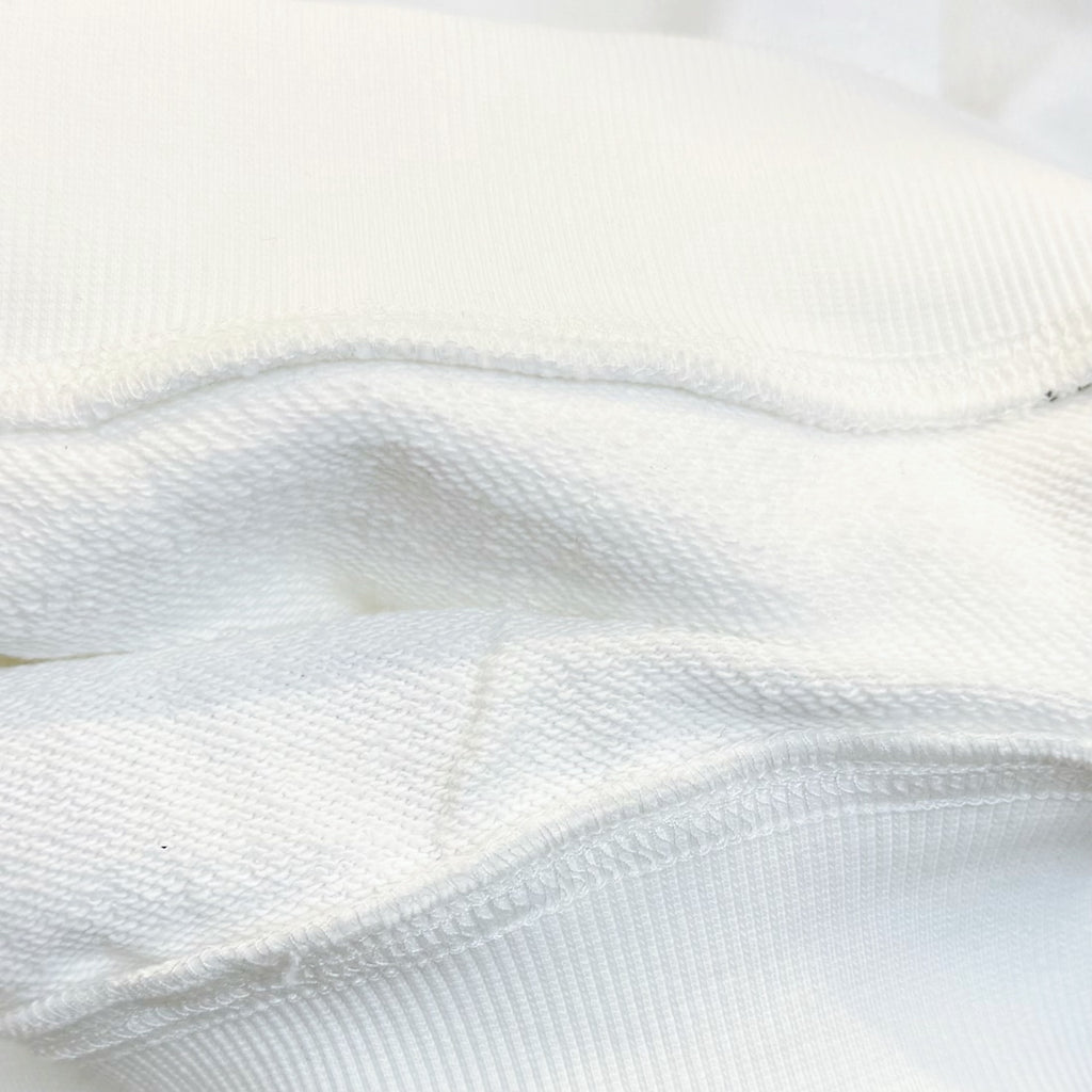 White long-sleeve garment fabric close-up