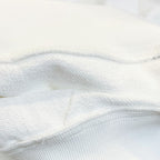 White long-sleeve garment fabric close-up