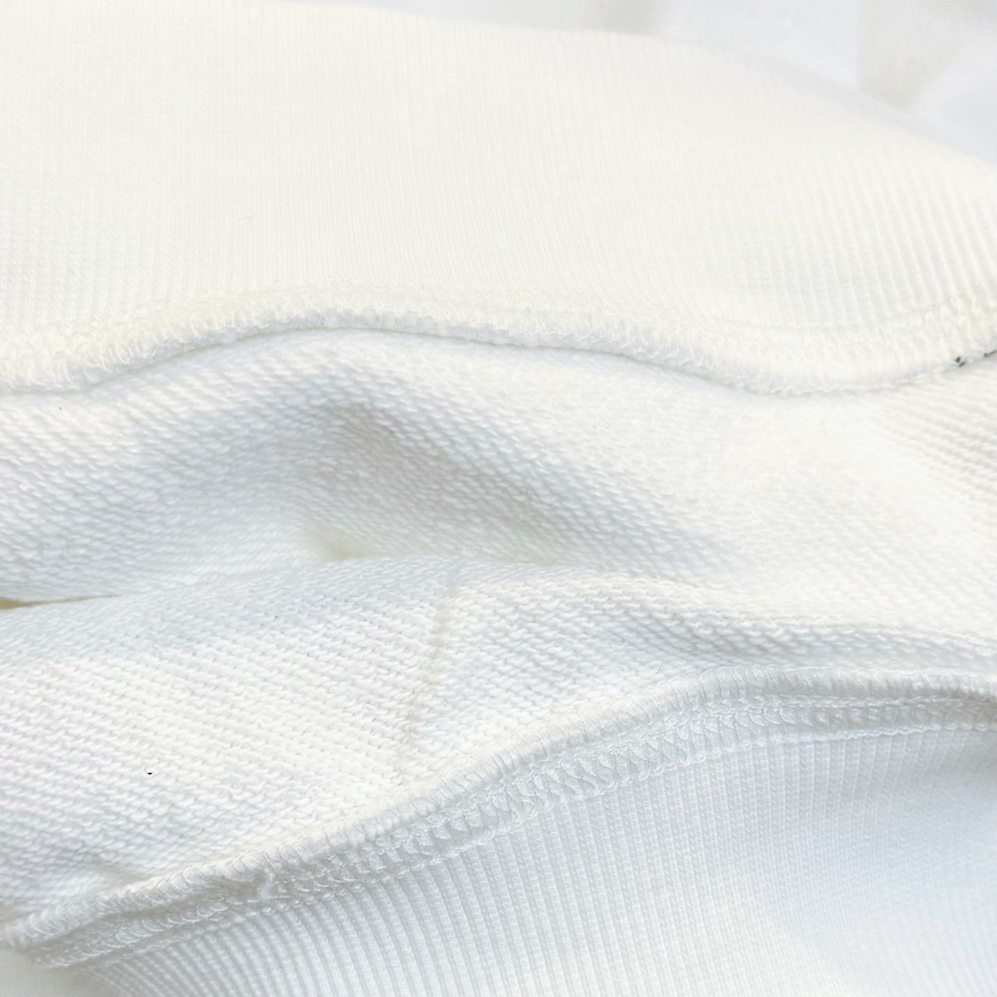 White long-sleeve garment fabric close-up