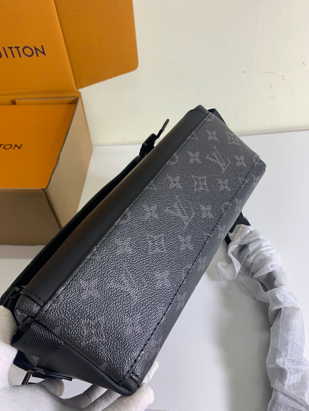 Louis Vuitton monogram crossbody bag side view with textured finish and strap