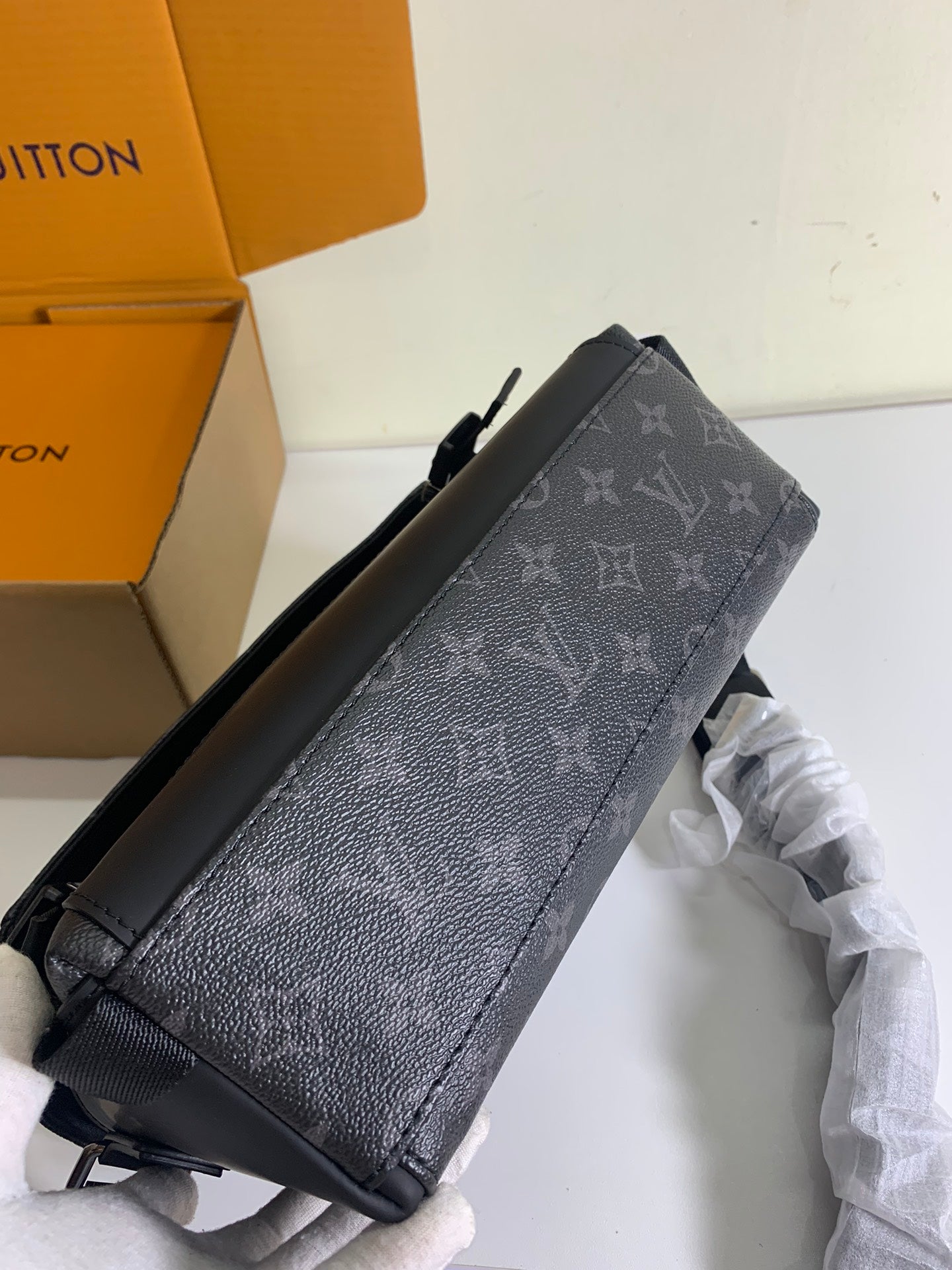 Louis Vuitton monogram crossbody bag side view with textured finish and strap