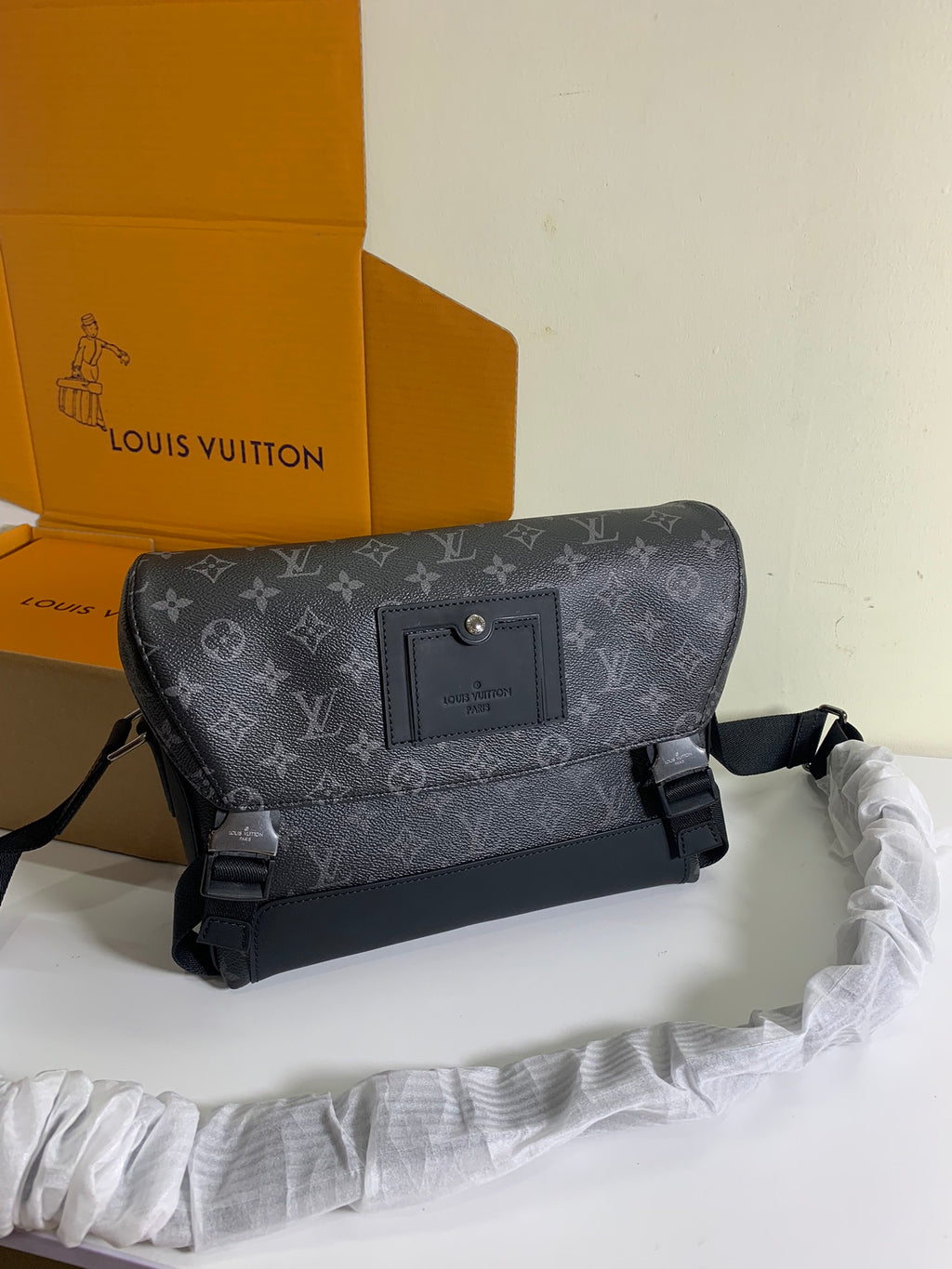 Louis Vuitton monogram shoulder bag with front flap, strap, and adjustable side buckles