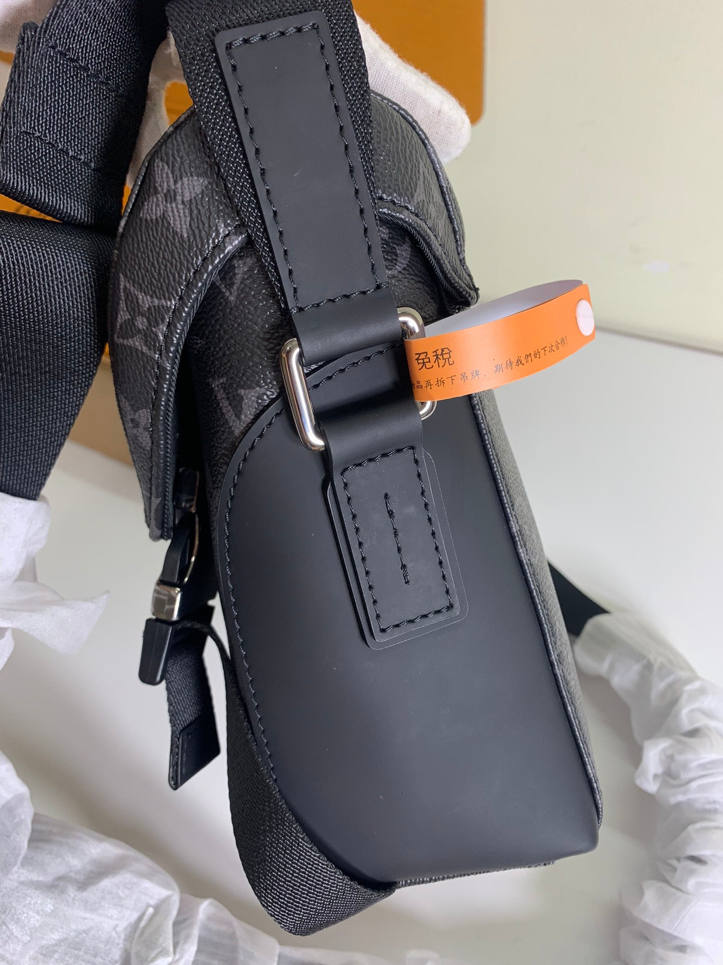 Louis Vuitton monogram bag with leather side strap and metal buckle hardware