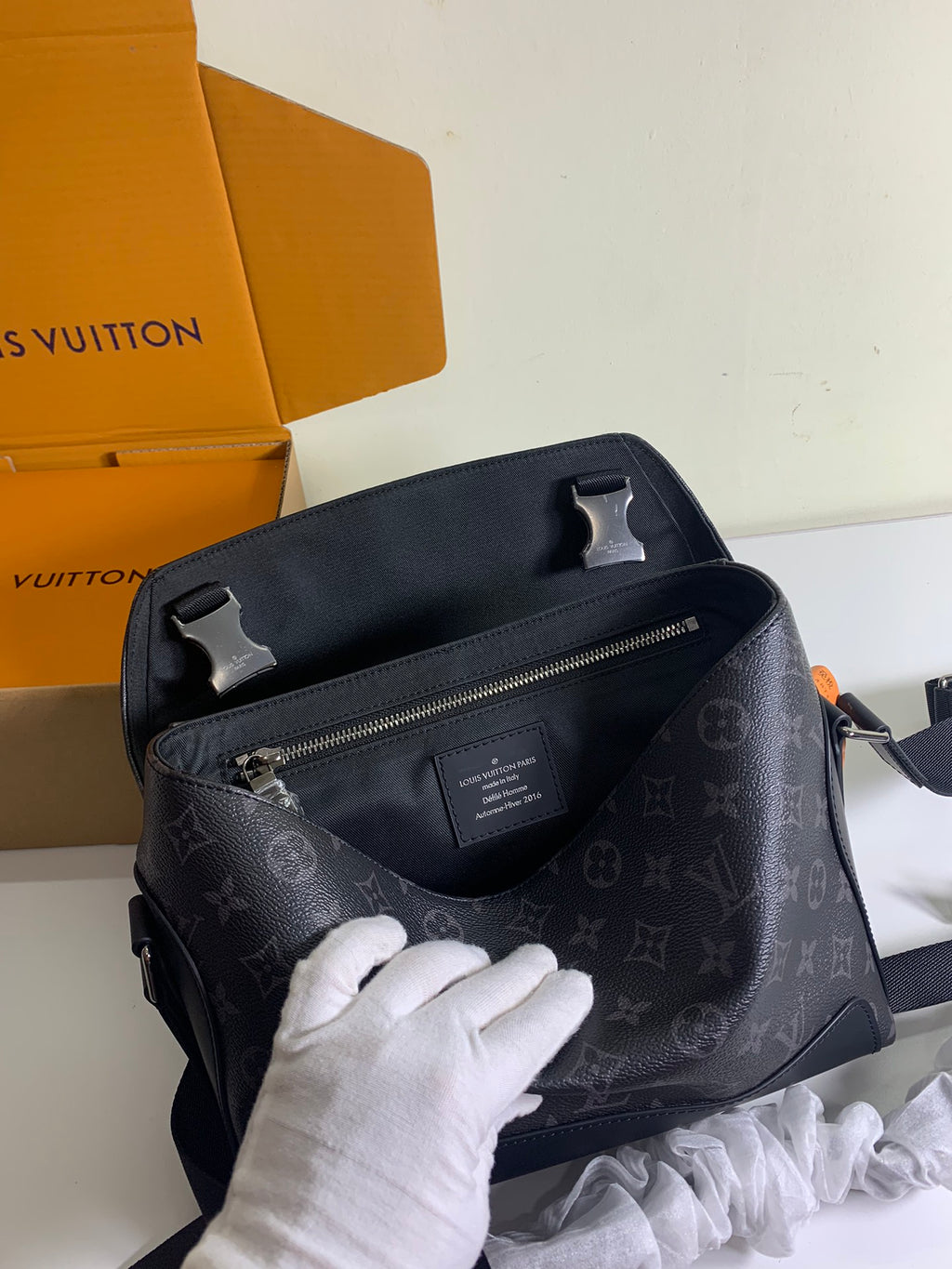 Louis Vuitton monogram shoulder bag with top handle, front zip pocket, and dark hardware