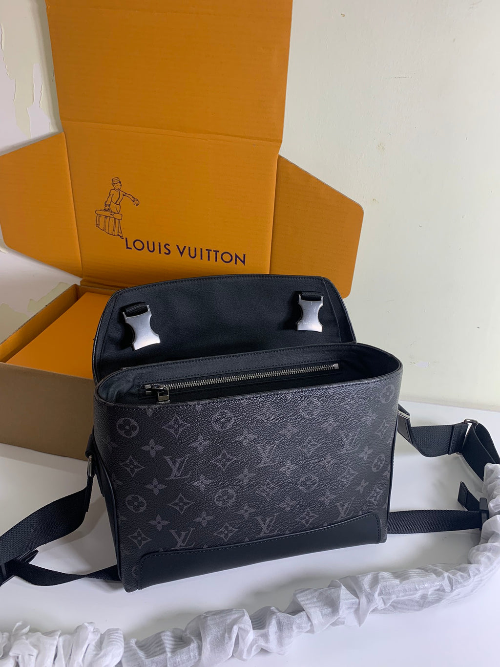 Louis Vuitton monogram crossbody bag with adjustable strap and front zip opening
