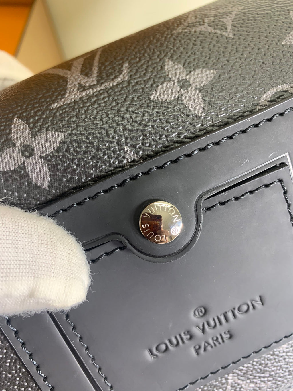 Louis Vuitton monogram crossbody bag close-up of logo snap and flap hardware
