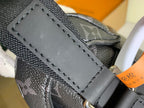Louis Vuitton monogram bag close-up of stitched leather flap and front label panel
