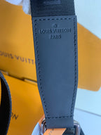 Louis Vuitton PARIS stamped on blue leather crossbody strap end with stitching.