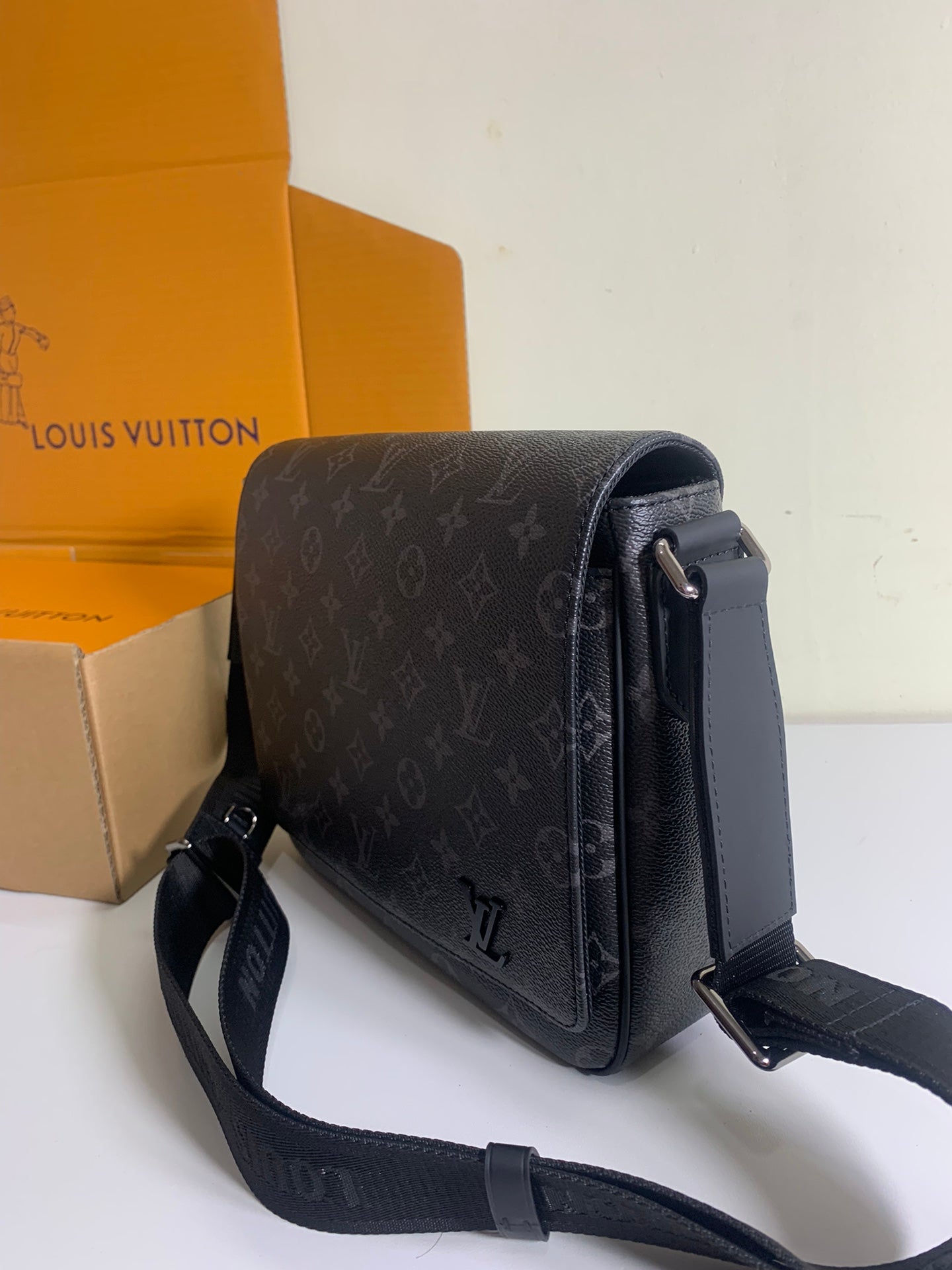 Louis Vuitton monogram crossbody bag with flap and silver hardware, dark gray.