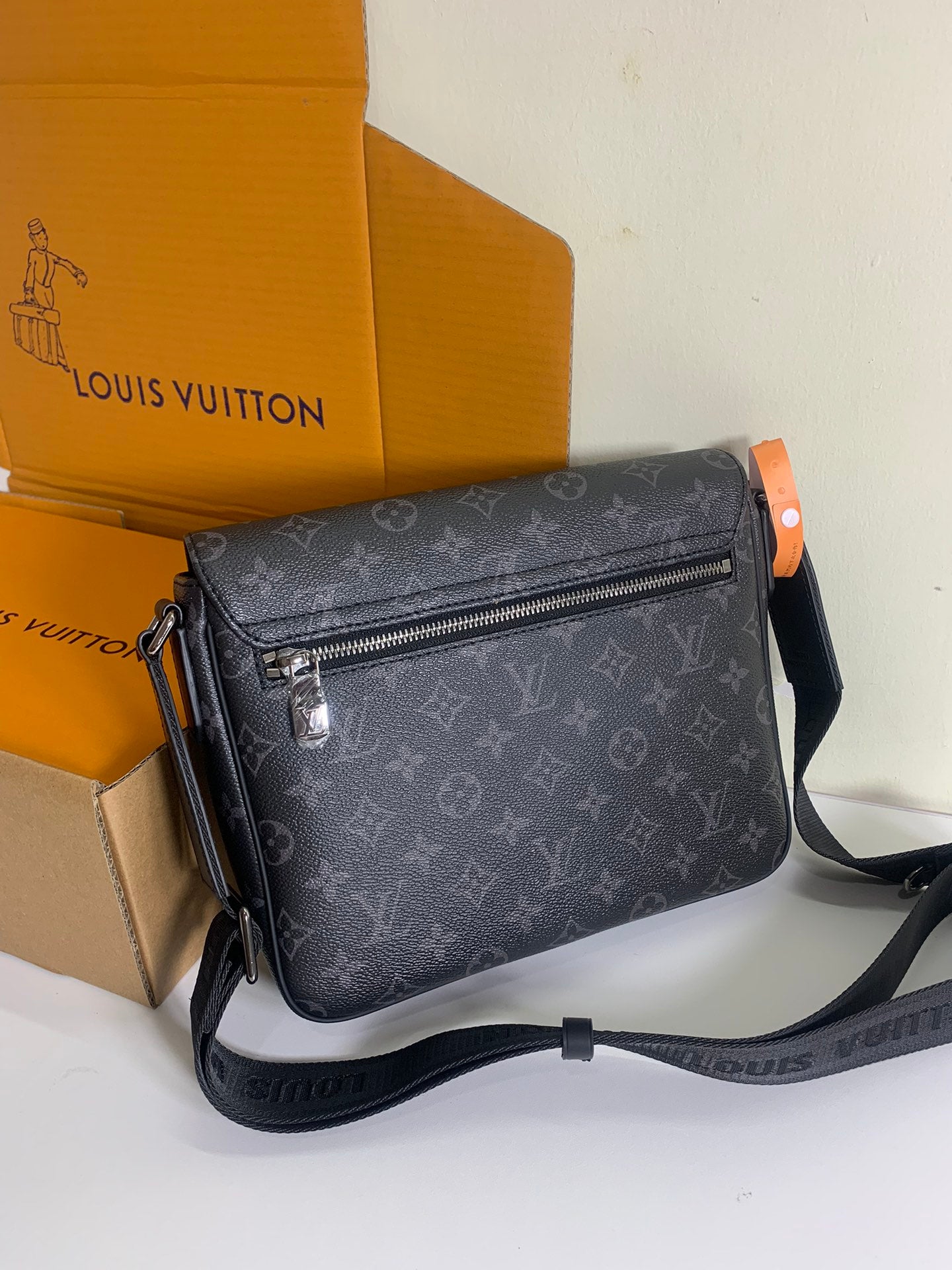 Louis Vuitton monogram crossbody bag with top zip, dark gray patterned canvas.