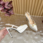 Gucci women's white slingback heels held in hand, gold horsebit detail and thin heel