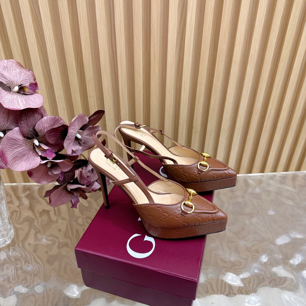 Brown Gucci slingback heeled mules with gold buckles and pointed toes