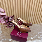 Brown Gucci slingback heeled mules with gold buckles and pointed toes