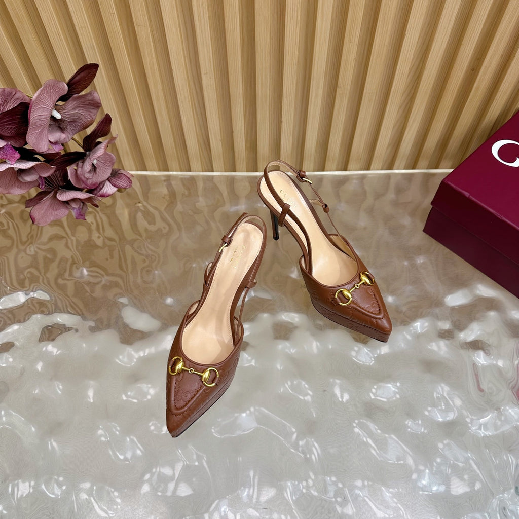 Brown Gucci slingback heeled mules with stiletto heels and gold ring buckle, side view