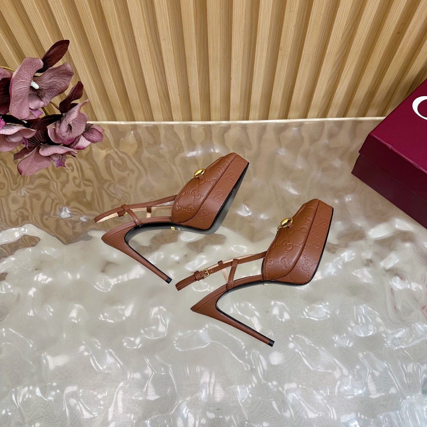 Brown Gucci slingback heeled mules with thin stiletto heel, sling straps, gold buckles