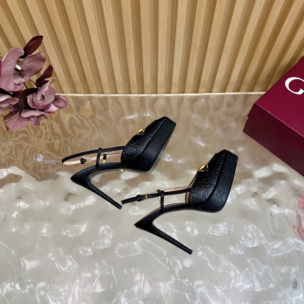 Black slingback stiletto heels with gold ring buckle, rear view of heel