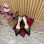 Black slingback stiletto heels with gold ring buckle, pointed toe
