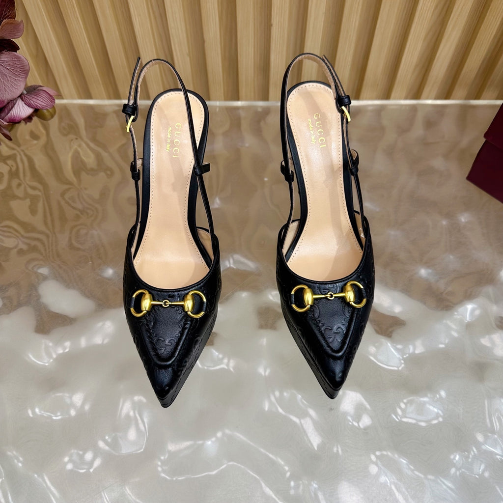 Black slingback heels with gold ring buckle and thin stiletto heel