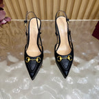Black slingback heels with gold ring buckle and thin stiletto heel