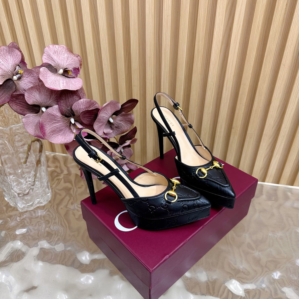 Pair of black slingback stiletto heels with gold hardware and high heel