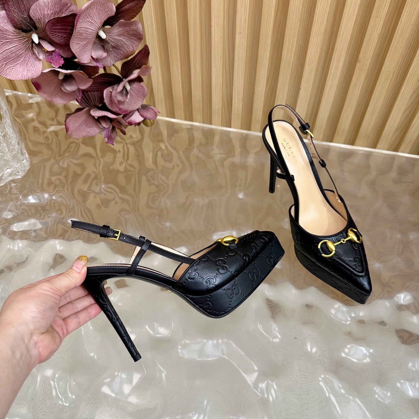 Black slingback stiletto heels with gold ring buckle and textured upper