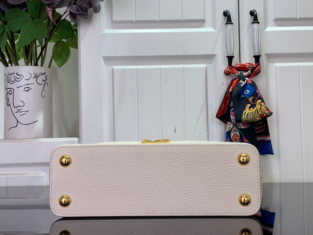 Louis Vuitton bag in white textured leather with snap closure and gold studs