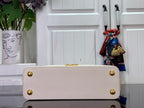 Louis Vuitton bag in white textured leather with snap closure and gold studs