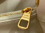 Louis Vuitton gold zipper pull on white textured leather bag