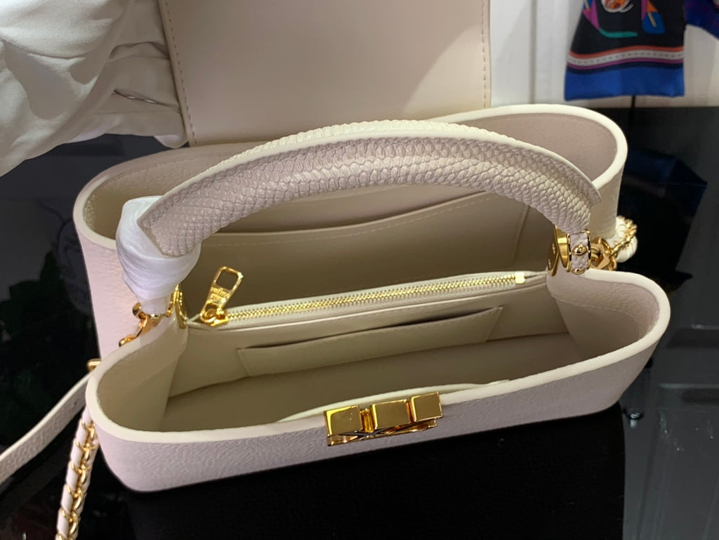 Louis Vuitton bag open with white interior, zipper, and gold hardware