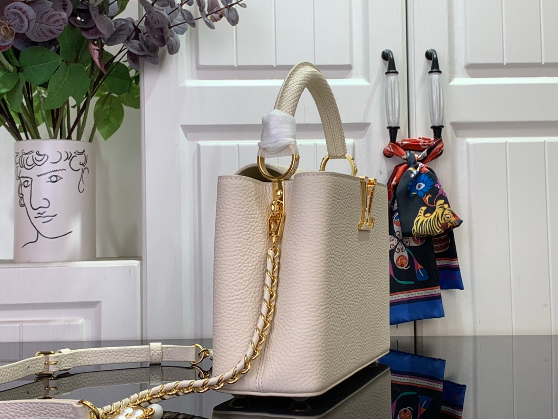 Louis Vuitton bag in white textured leather with structured tote shape and chain strap