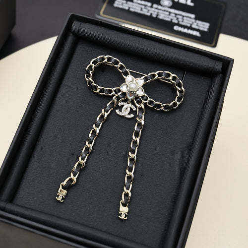 Chain charm necklace with floral pendant and long dangling chain drops on black display box