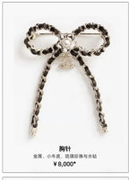 Floral motif chain charm necklace with two circular link loops and two long dangling chains