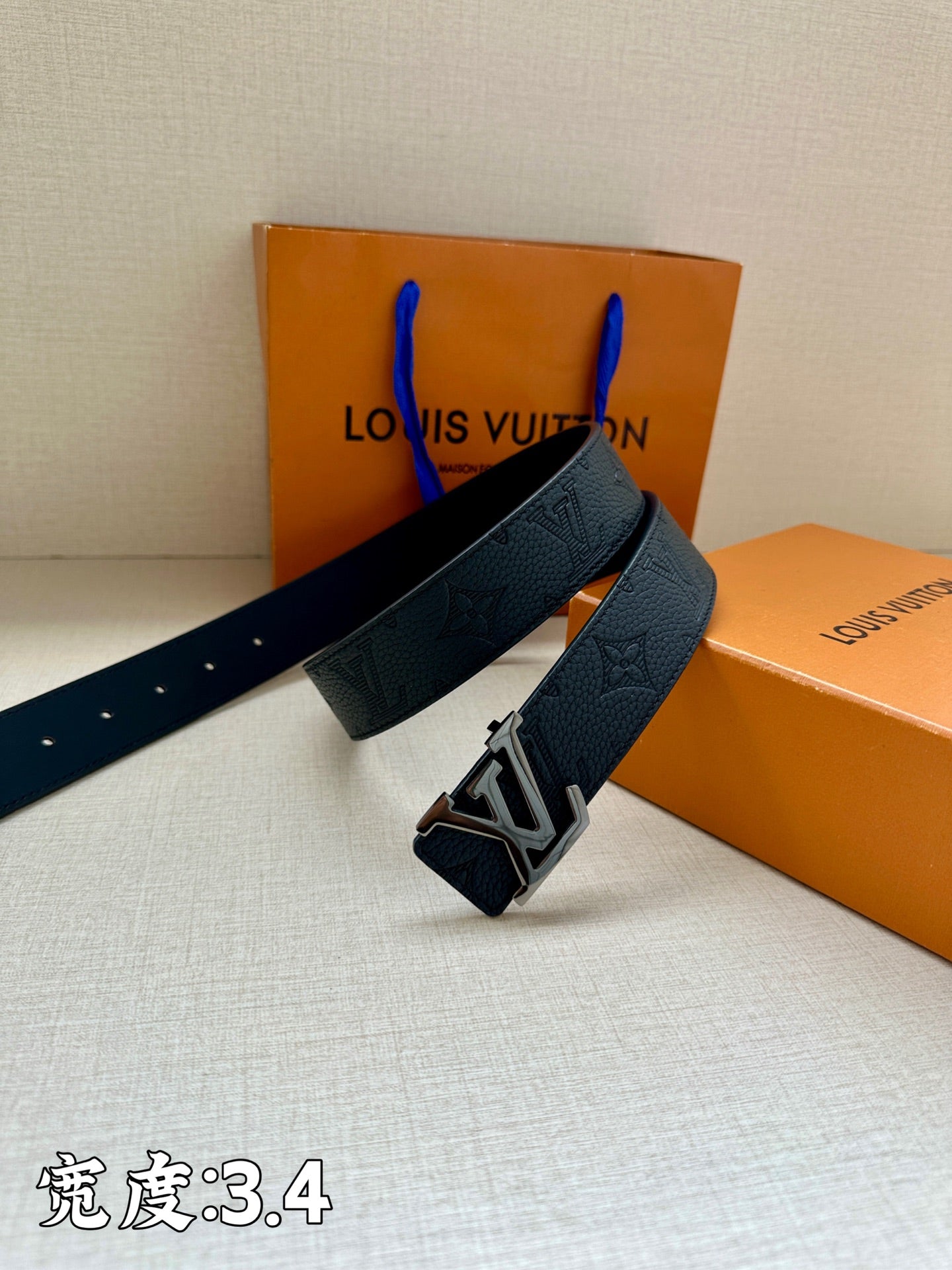 Dark blue leather belt with LV buckle and studded holes on the strap