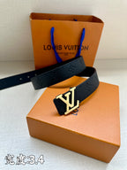 Dark blue leather belt with gold-tone LV buckle on top of the box