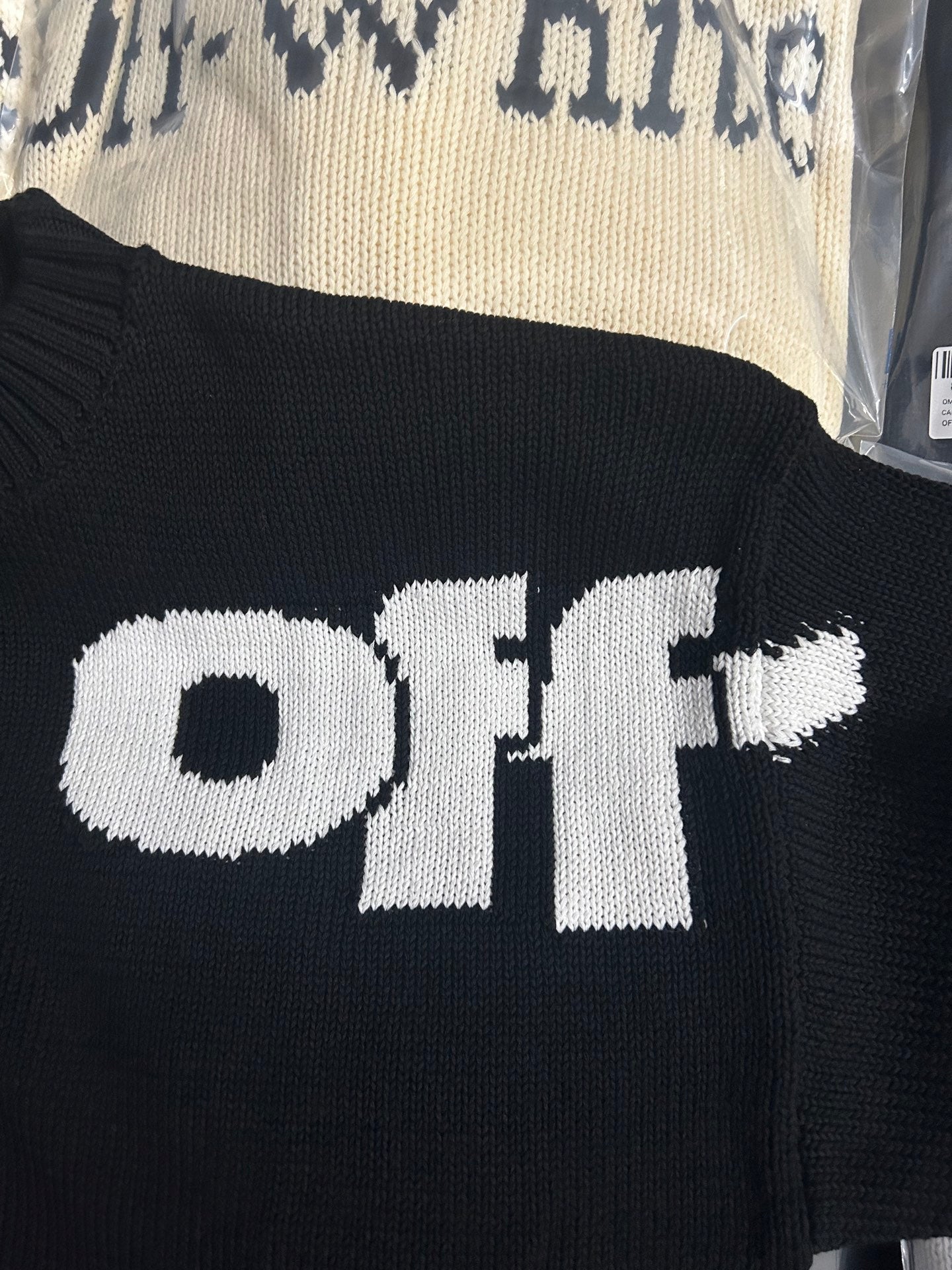 Black knit sweater with large white Off-White text logo across front