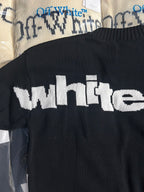 Black knit sweater back with large white 'white' text logo