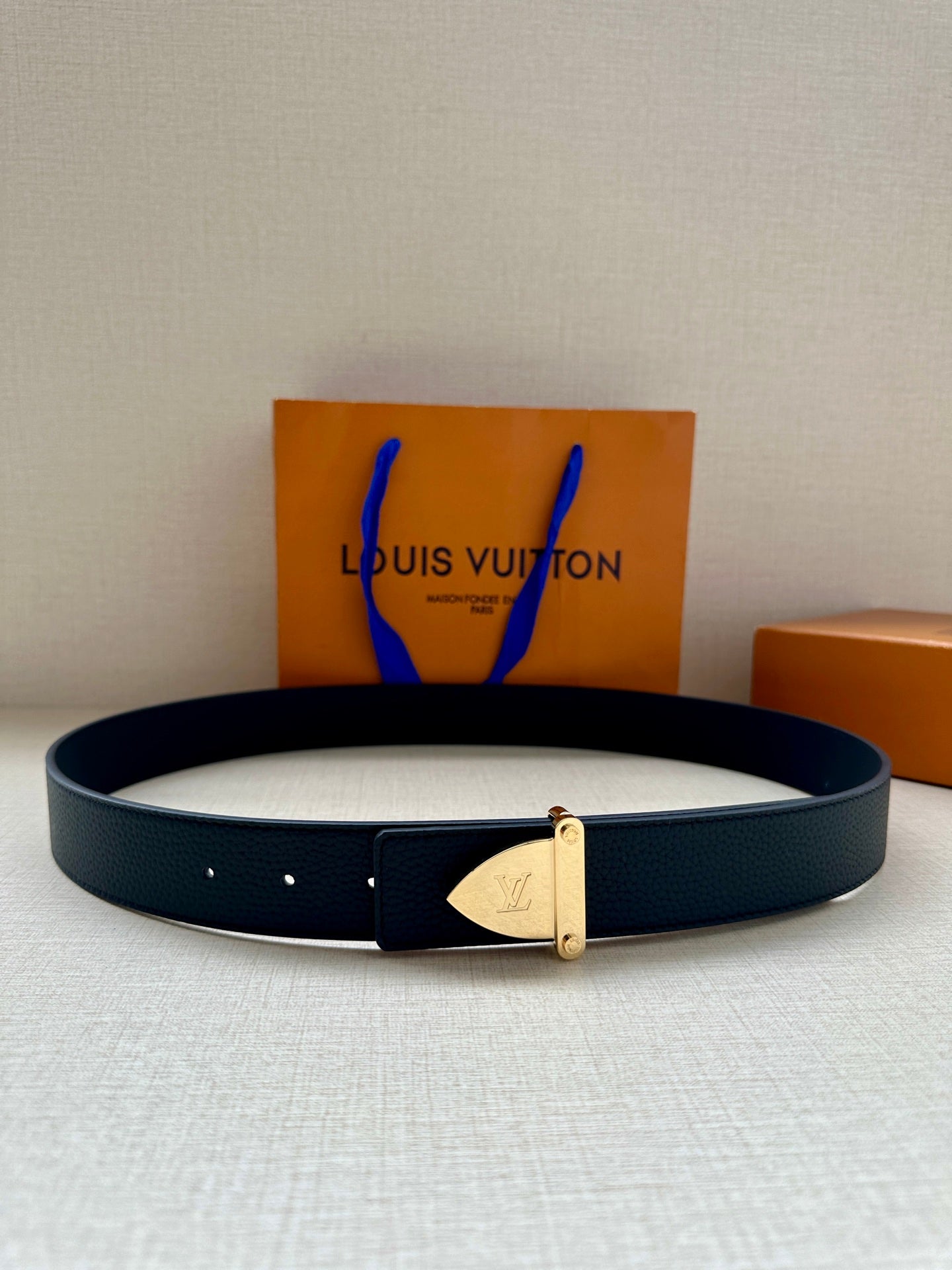 Louis Vuitton belt in dark blue leather with gold-tone buckle and keeper