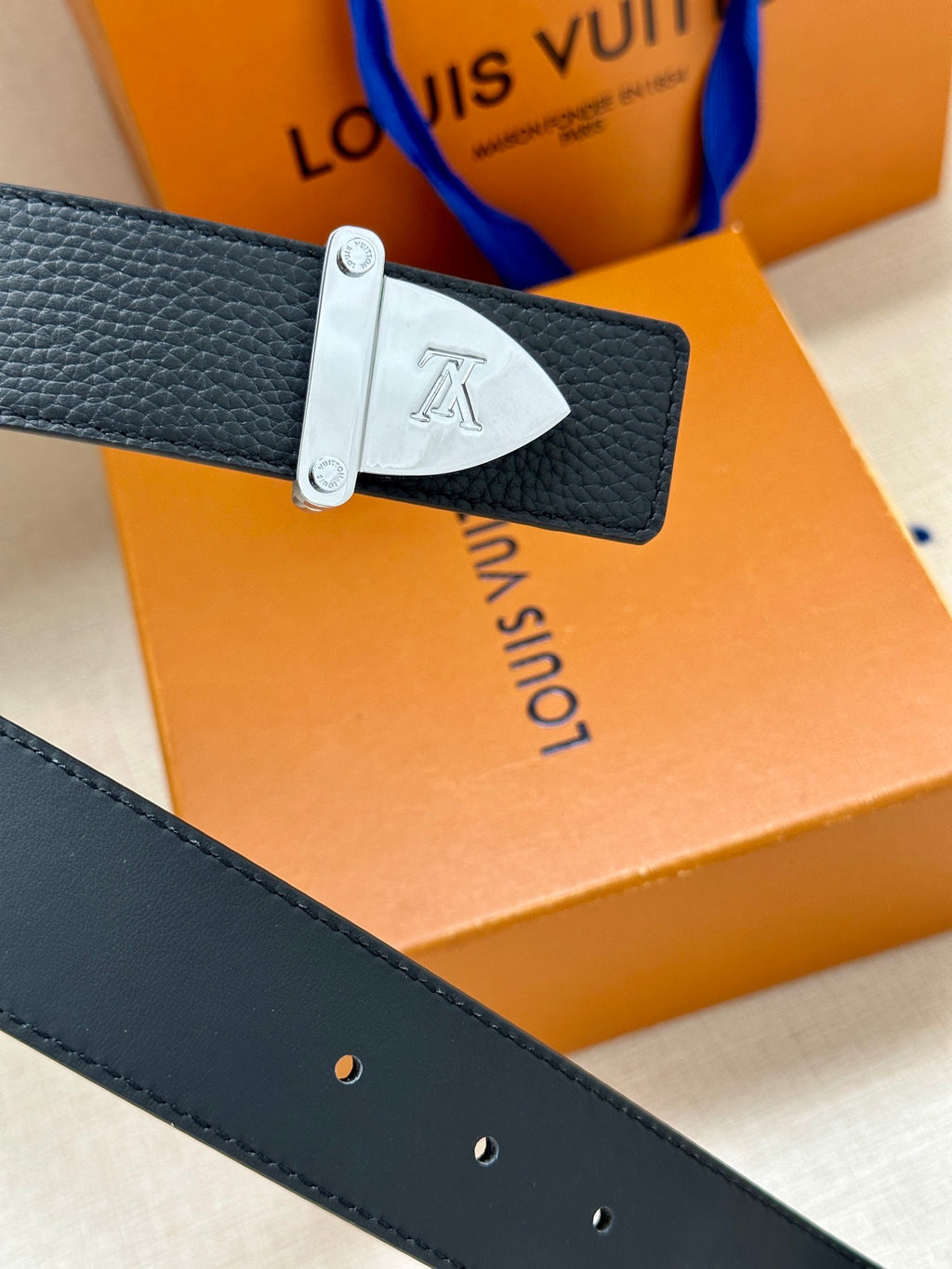 Louis Vuitton belt with dark blue leather strap and silver-tone buckle
