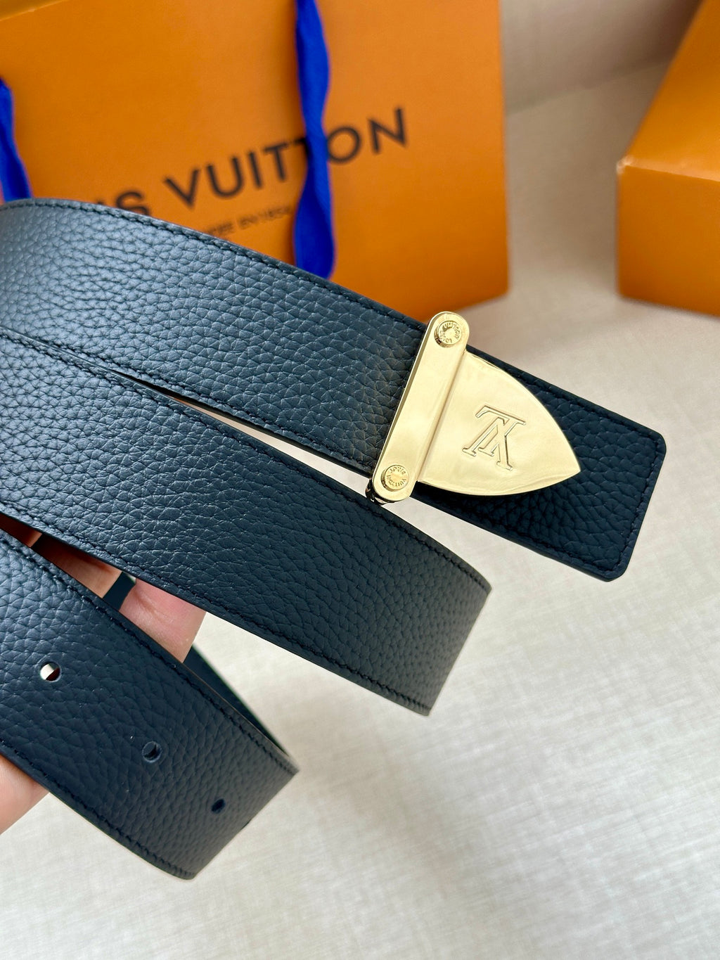 Louis Vuitton belt with dark blue leather strap and gold-tone clasp buckle