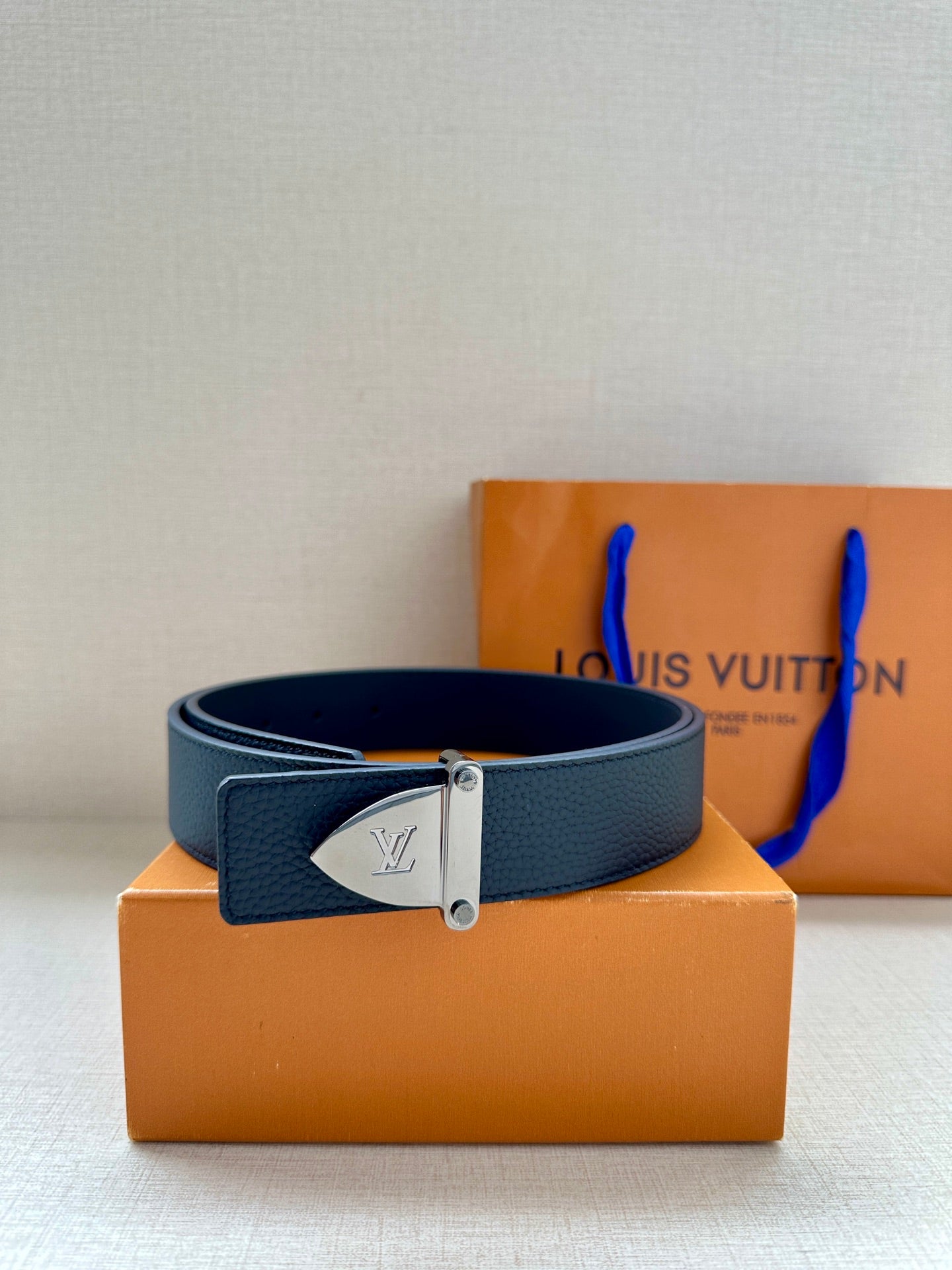 Louis Vuitton belt in dark blue leather with gold-tone buckle on box