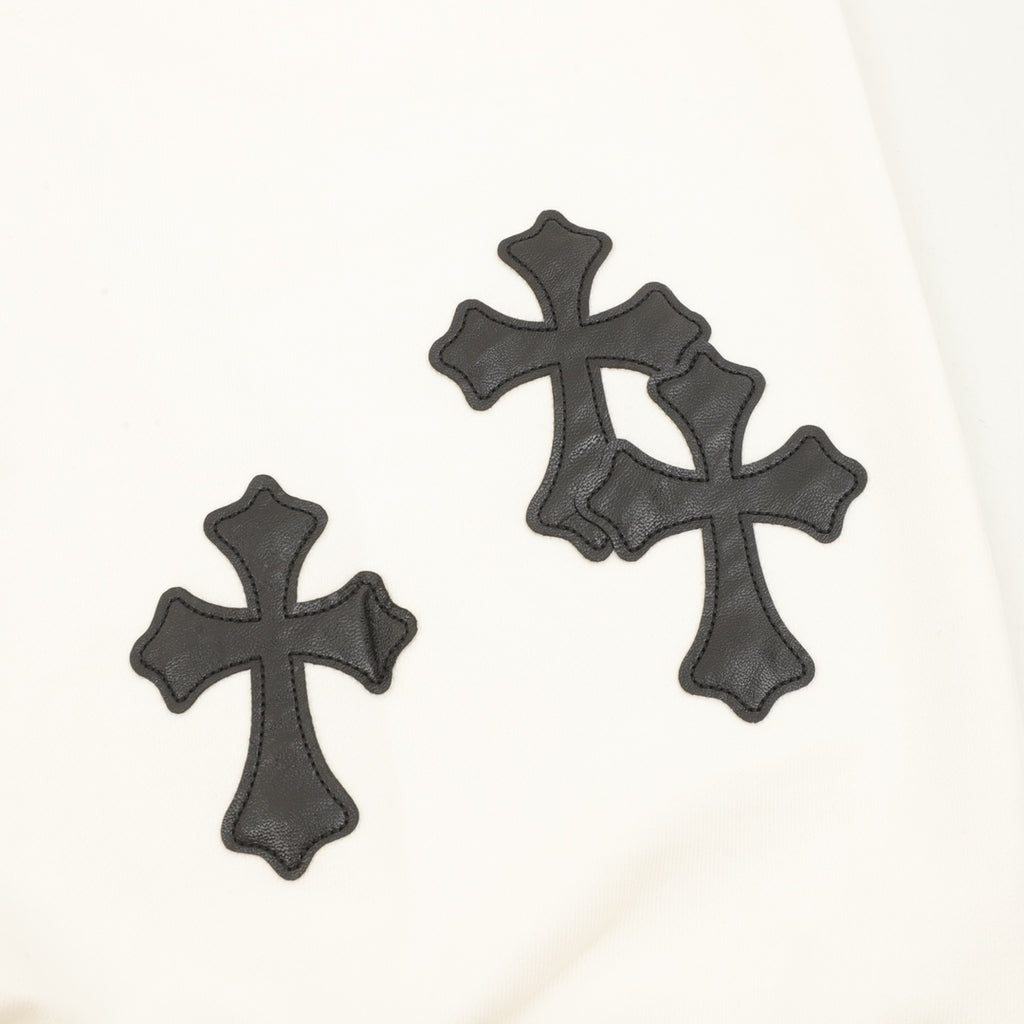 Cream sweatshirt with three black embroidered cross appliqués