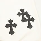 Cream sweatshirt with three black embroidered cross appliqués