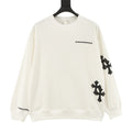 Cream long-sleeve crewneck sweatshirt with black cross patches on sleeves